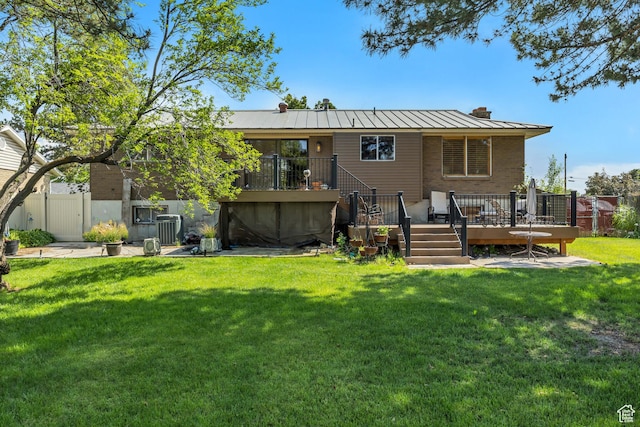 371 E 6770 S, Midvale, UT 84047 - back of house featuring a standing seam roof, a wooden deck, a chimney, metal roof, and stairs