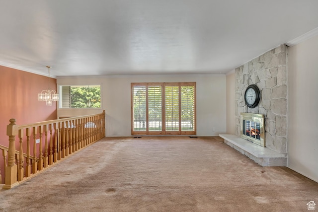 371 E 6770 S, Midvale, UT 84047 - unfurnished living room featuring a chandelier, crown molding, plenty of natural light, carpet, and a stone fireplace
