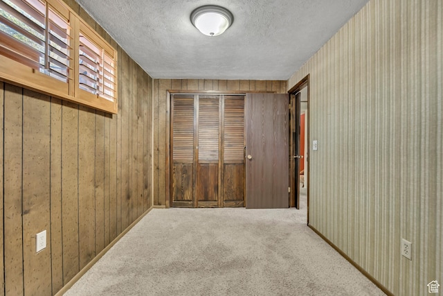371 E 6770 S, Midvale, UT 84047 - hallway featuring a textured ceiling, carpet floors, and wooden walls