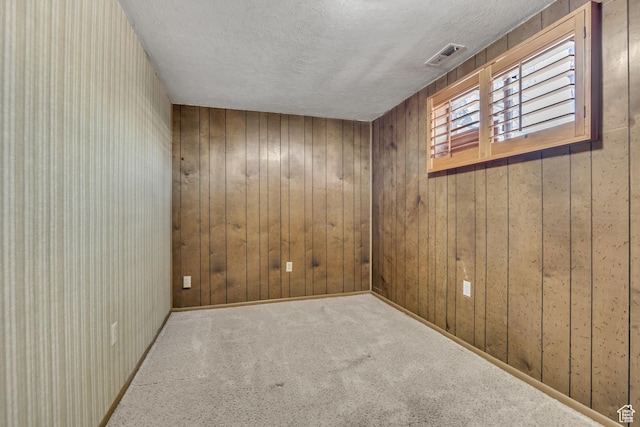 371 E 6770 S, Midvale, UT 84047 - unfurnished room featuring a textured ceiling, wooden walls, and carpet flooring