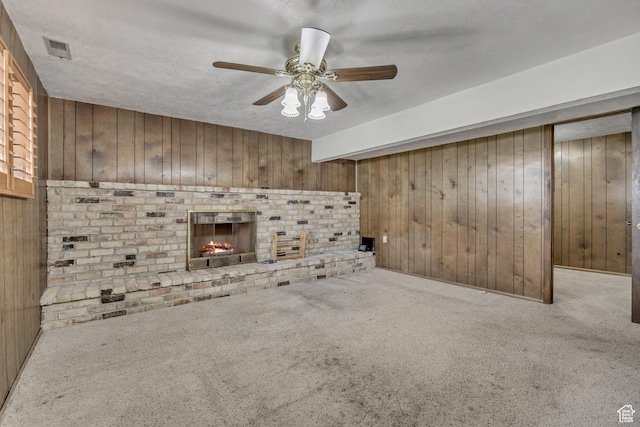 371 E 6770 S, Midvale, UT 84047 - unfurnished living room featuring wooden walls, a fireplace, carpet, and a ceiling fan
