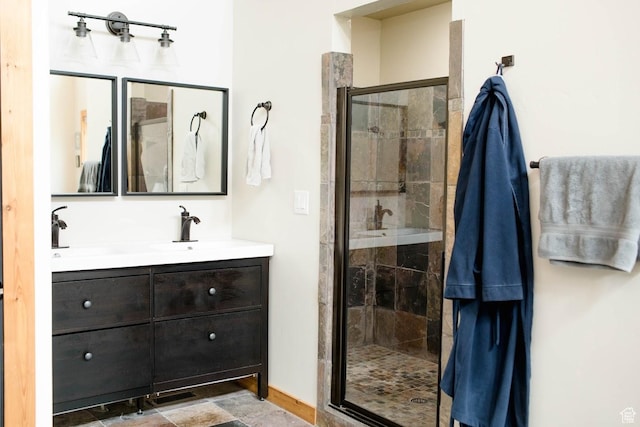 full bath with a shower stall and vanity