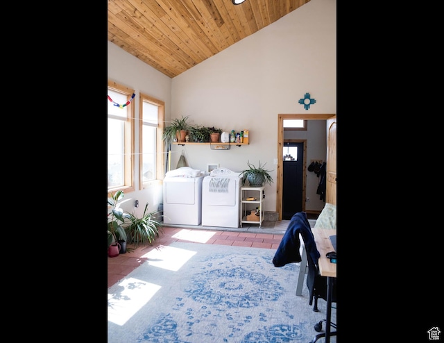clothes washing area featuring a high ceiling, tile patterned floors, laundry area, wooden ceiling, and independent washer and dryer
