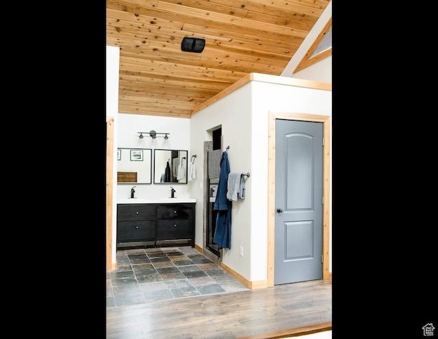 mudroom featuring wood ceiling, baseboards, and lofted ceiling