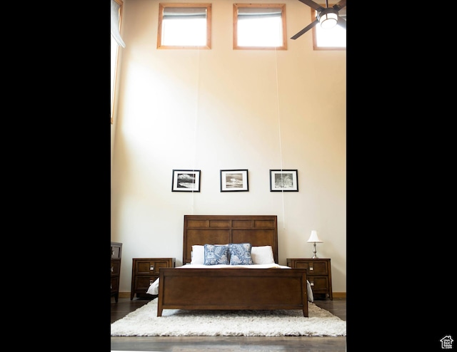 bedroom featuring wood finished floors and baseboards