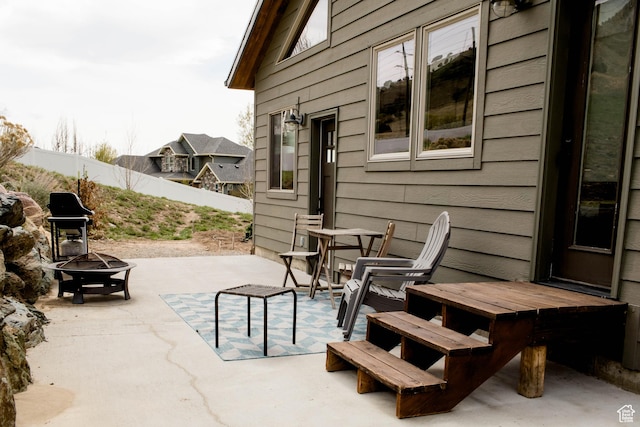 view of patio with a fire pit and fence