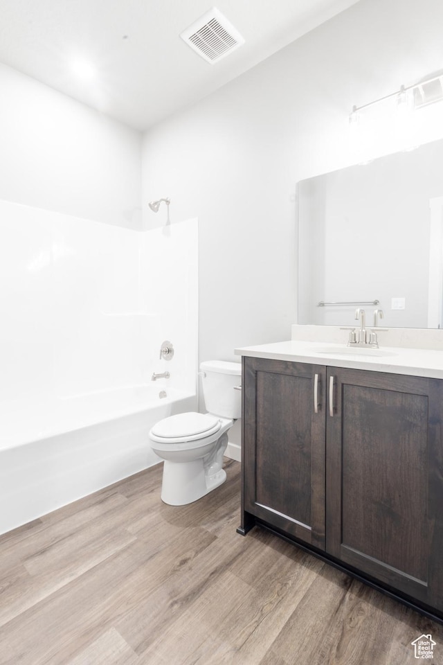 2833 W 3050 N Unit 11, Plain City, UT 84404 - bathroom with wood finished floors, vanity, washtub / shower combination, toilet, and visible vents