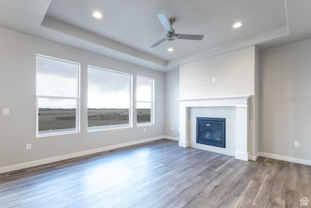 2833 W 3050 N Unit 11, Plain City, UT 84404 - unfurnished living room with wood finished floors, a tray ceiling, and visible vents