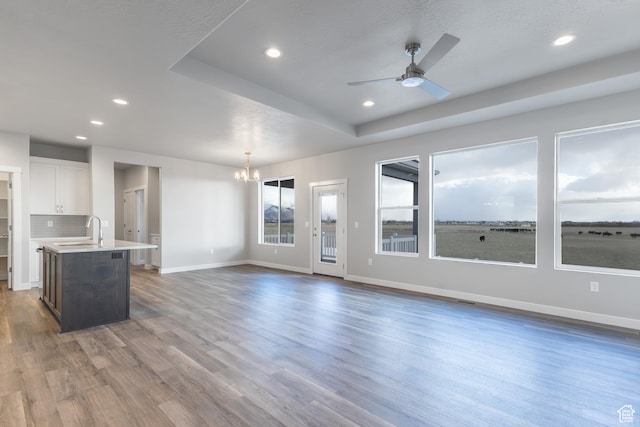2833 W 3050 N Unit 11, Plain City, UT 84404 - unfurnished living room featuring recessed lighting, wood finished floors, and ceiling fan with notable chandelier