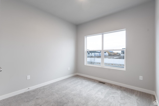 2833 W 3050 N Unit 11, Plain City, UT 84404 - spare room with light carpet, visible vents, and baseboards