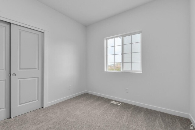 6737 N Tulle Mtn, Eagle Mountain, UT 84005 - unfurnished bedroom with baseboards, carpet flooring, visible vents, and a closet