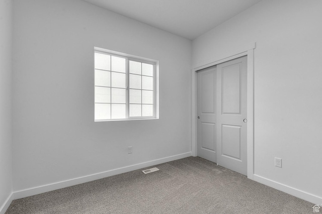 6737 N Tulle Mtn, Eagle Mountain, UT 84005 - unfurnished bedroom with a closet, carpet, visible vents, and baseboards