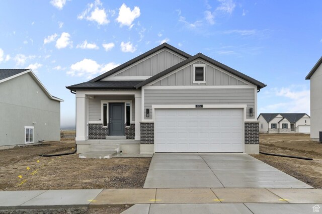 6737 N Tulle Mtn, Eagle Mountain, UT 84005 - craftsman-style house with board and batten siding, an attached garage, driveway, and brick siding