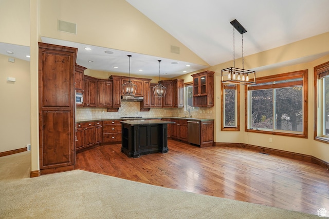 1321 E Farm Hill Dr, Salt Lake City, UT 84117 - kitchen with stainless steel appliances, a center island, a sink, visible vents, and backsplash
