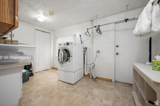 336 W 200 N, Bountiful, UT 84010 - laundry room featuring cabinet space, washer / dryer, a textured ceiling, stone finish floor, and baseboards