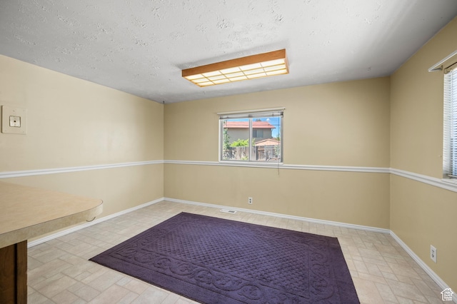 336 W 200 N, Bountiful, UT 84010 - unfurnished room with baseboards, a healthy amount of sunlight, and a textured ceiling