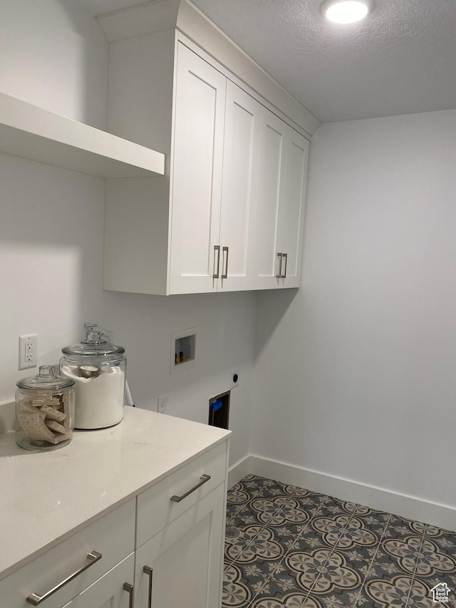 332 N 3250 W Unit 3, West Point, UT 84015 - laundry area featuring hookup for an electric dryer, baseboards, cabinet space, washer hookup, and a textured ceiling