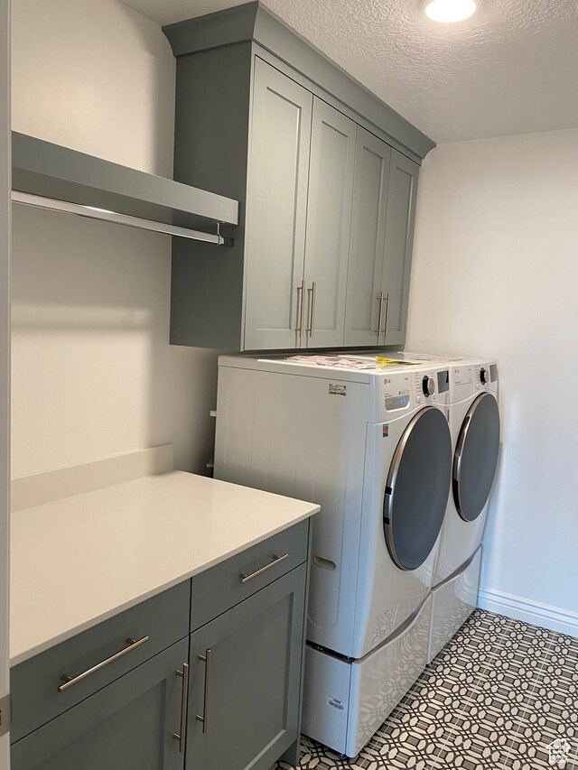 332 N 3250 W Unit 3, West Point, UT 84015 - laundry room with washing machine and clothes dryer, cabinet space, a textured ceiling, and baseboards