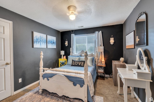 bedroom featuring a textured ceiling, carpet flooring, a ceiling fan, and visible vents