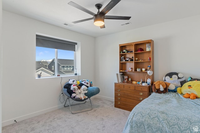 carpeted bedroom featuring visible vents, a ceiling fan, and baseboards
