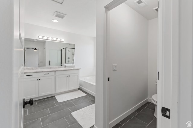bathroom with toilet, vanity, tile patterned floors, and visible vents