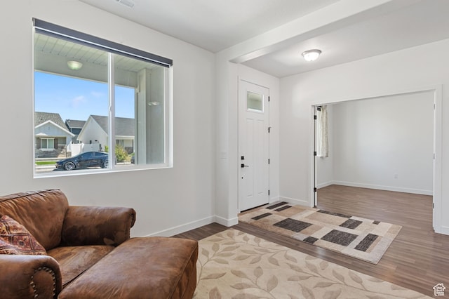 entrance foyer featuring baseboards, wood finished floors, and visible vents