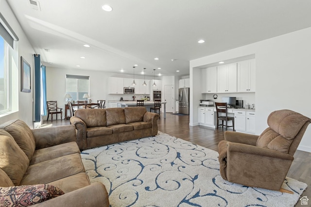living area with recessed lighting, visible vents, and dark wood-style floors