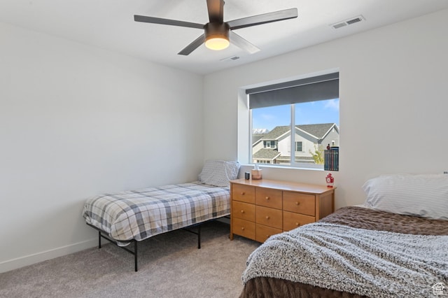 bedroom featuring baseboards, a ceiling fan, visible vents, and light colored carpet