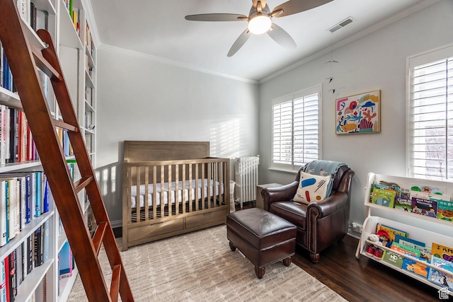 1283 E S Temple Unit 503, Salt Lake City, UT 84102 - bedroom featuring wood finished floors, ornamental molding, a crib, and ceiling fan