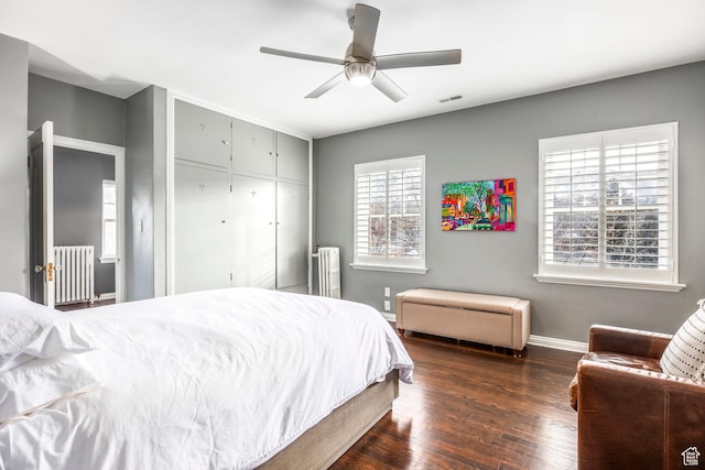 1283 E S Temple Unit 503, Salt Lake City, UT 84102 - bedroom with radiator heating unit, baseboards, dark wood-style floors, and a closet