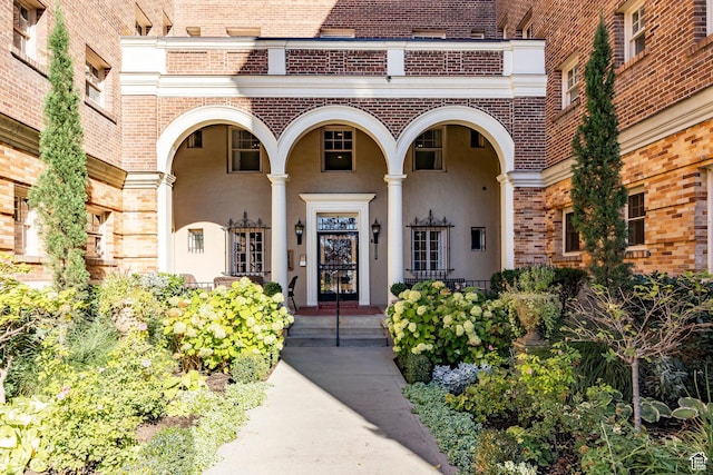 1283 E S Temple Unit 503, Salt Lake City, UT 84102 - doorway to property with brick siding, stucco siding, and a porch