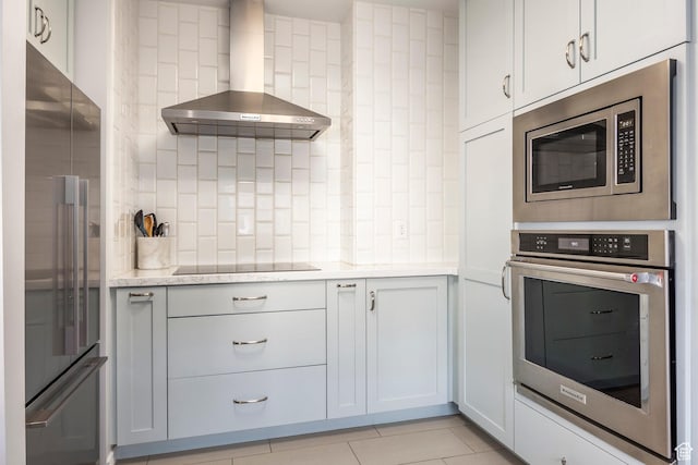 1283 E S Temple Unit 503, Salt Lake City, UT 84102 - kitchen featuring appliances with stainless steel finishes, wall chimney exhaust hood, light tile patterned floors, and backsplash