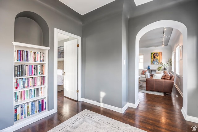 1283 E S Temple Unit 503, Salt Lake City, UT 84102 - hallway featuring arched walkways, wood finished floors, rail lighting, and baseboards