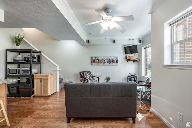 2503 S 160 E Unit 6D, Ogden, UT 84401 - living area with stairway, crown molding, light wood-style flooring, and ceiling fan