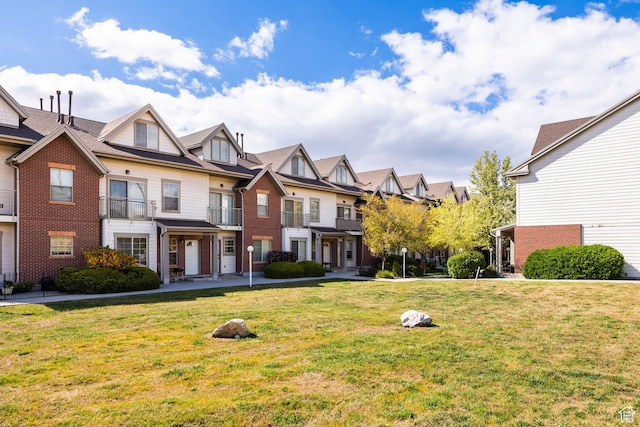 2503 S 160 E Unit 6D, Ogden, UT 84401 - townhome / multi-family property featuring a front lawn, brick siding, and a residential view