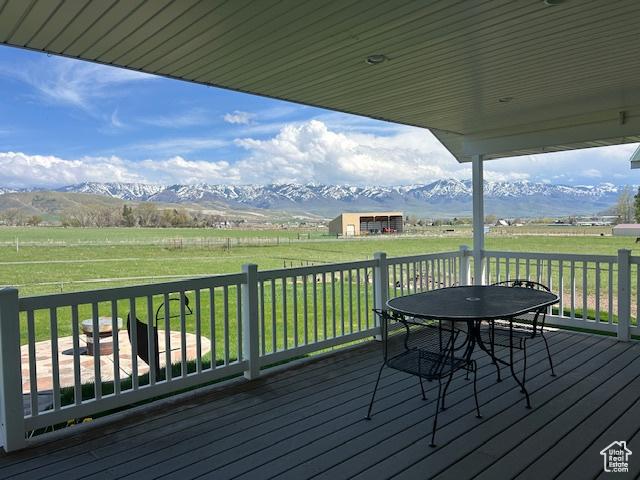 1176 E 900 S, Preston, ID 83263 - wooden terrace featuring a lawn, a rural view, a mountain view, and outdoor dining area