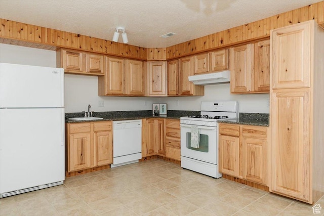 1176 E 900 S, Preston, ID 83263 - kitchen featuring white appliances, under cabinet range hood, dark stone counters, light brown cabinets, and a textured ceiling