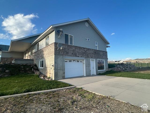 1176 E 900 S, Preston, ID 83263 - view of home's exterior with driveway, a yard, and an attached garage