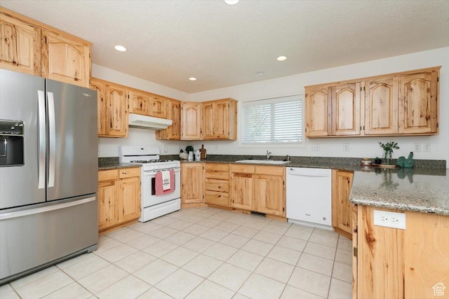 1176 E 900 S, Preston, ID 83263 - kitchen with white appliances, under cabinet range hood, recessed lighting, dark stone counters, and light brown cabinetry