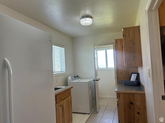 1176 E 900 S, Preston, ID 83263 - laundry area featuring baseboards, light tile patterned floors, washer / clothes dryer, and a textured ceiling