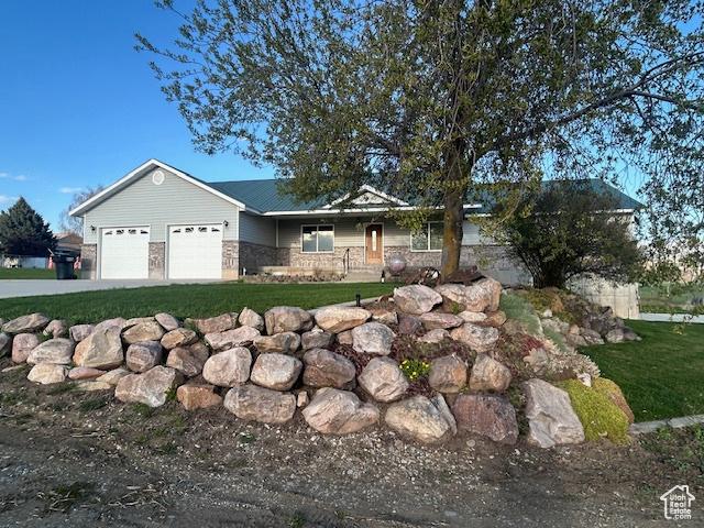 1176 E 900 S, Preston, ID 83263 - view of front of home with driveway, covered porch, a front lawn, and a garage
