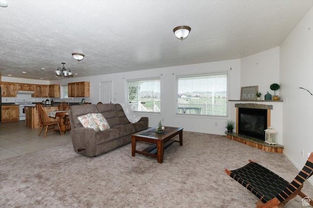 1176 E 900 S, Preston, ID 83263 - living area featuring a textured ceiling, a chandelier, a glass covered fireplace, and light colored carpet