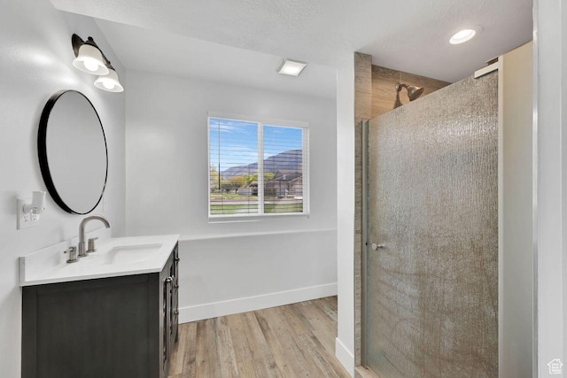 221 E Brookmeadow Dr, Harrisville, UT 84404 - full bath featuring vanity, wood finished floors, a stall shower, baseboards, and recessed lighting