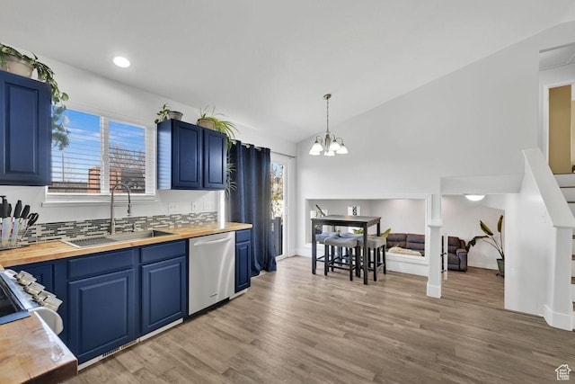 221 E Brookmeadow Dr, Harrisville, UT 84404 - kitchen featuring butcher block countertops, stainless steel dishwasher, a sink, blue cabinets, and vaulted ceiling