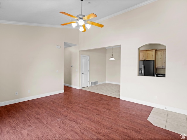 165 S Pleasant Grove Blvd Unit 45, Pleasant Grove, UT 84062 - unfurnished living room with a ceiling fan, light wood-style flooring, baseboards, ornamental molding, and visible vents