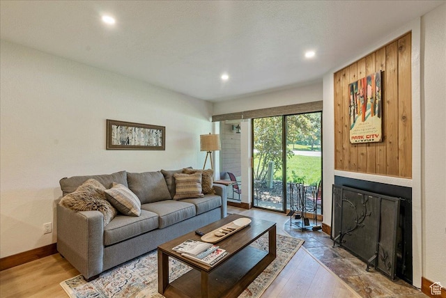 1530 Empire Ave Unit 112, Park City, UT 84060 - living room featuring a fireplace with flush hearth, baseboards, recessed lighting, and wood-type flooring
