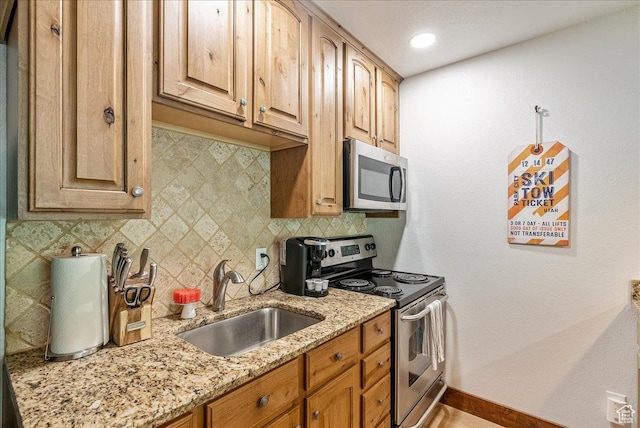 1530 Empire Ave Unit 112, Park City, UT 84060 - kitchen with stainless steel appliances, a sink, tasteful backsplash, baseboards, and light stone counters