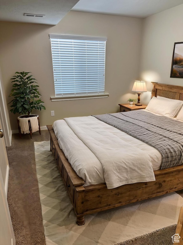 bedroom with light carpet, visible vents, and baseboards