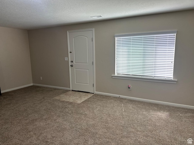 interior space featuring visible vents, baseboards, and a textured ceiling