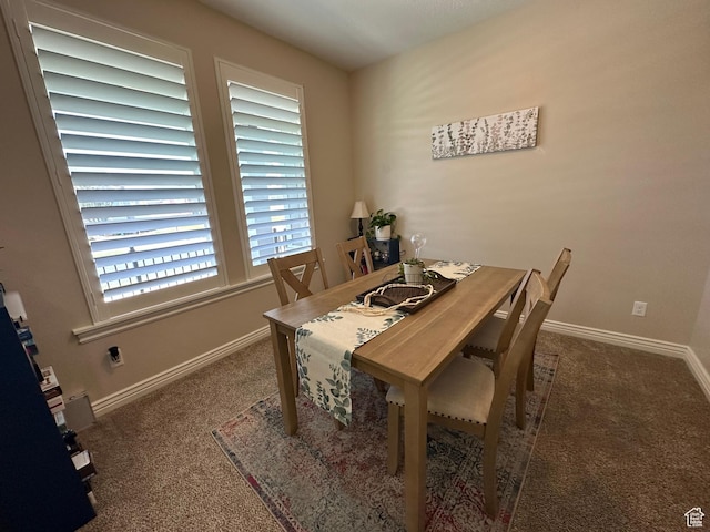 carpeted dining area with baseboards